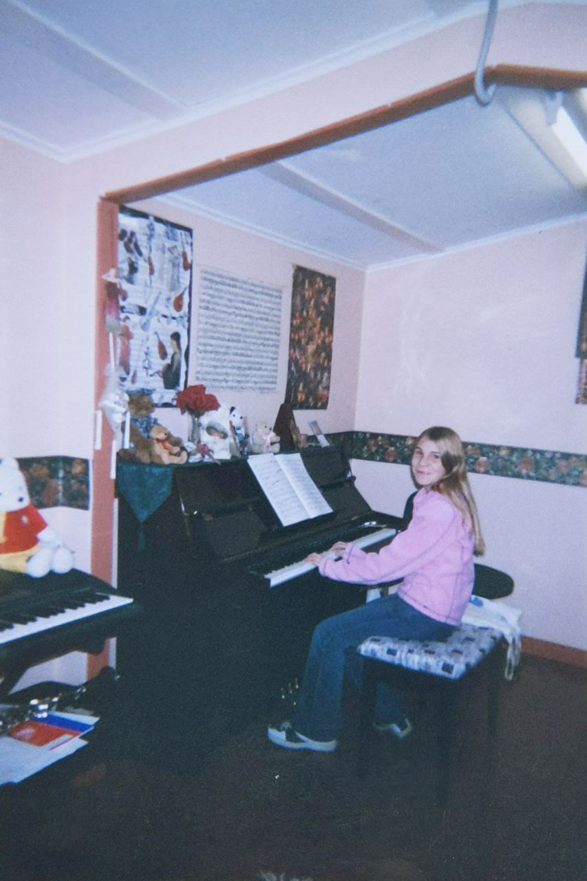Bri playing the piano at home