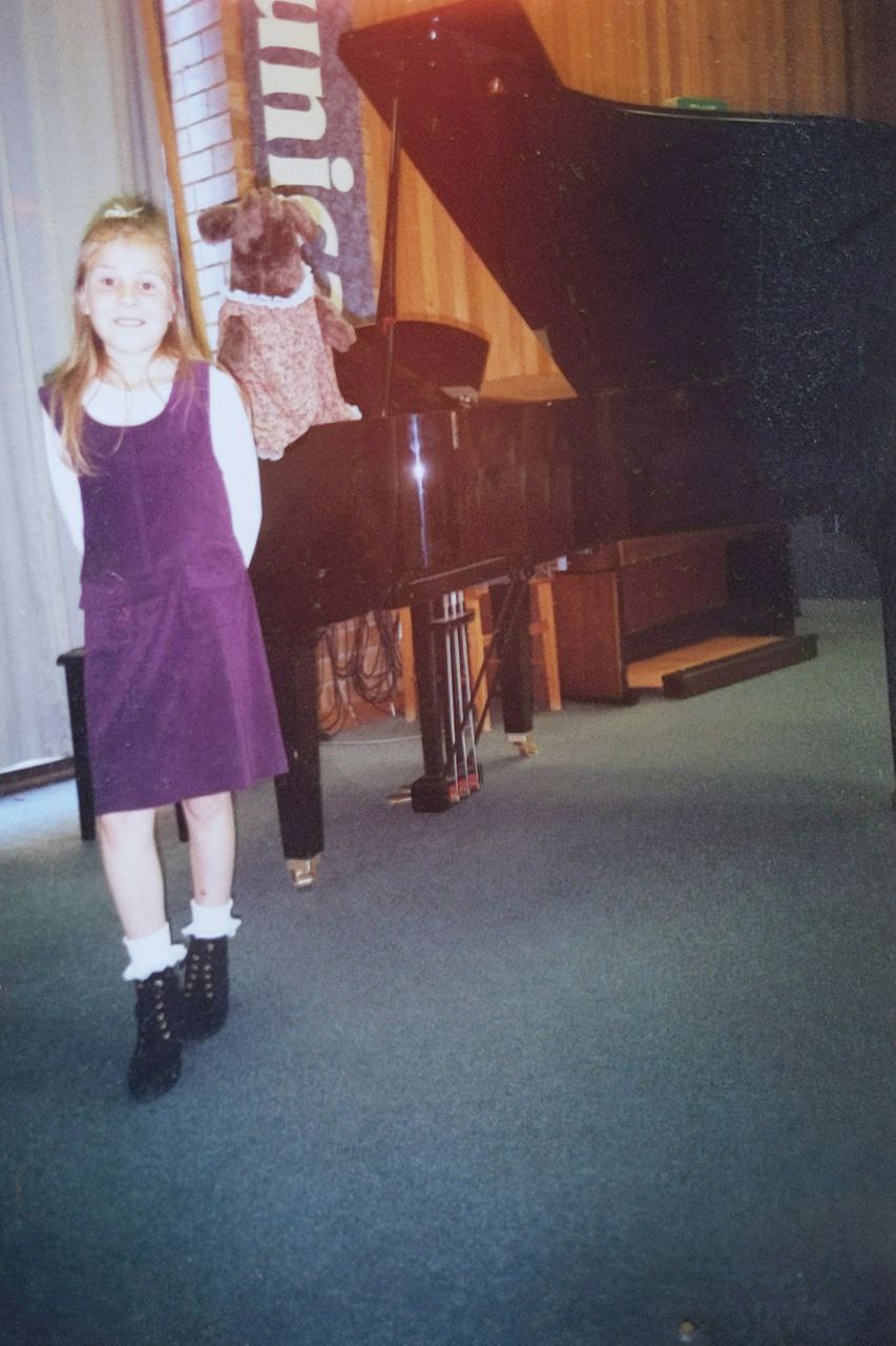 Bree next to a grand piano