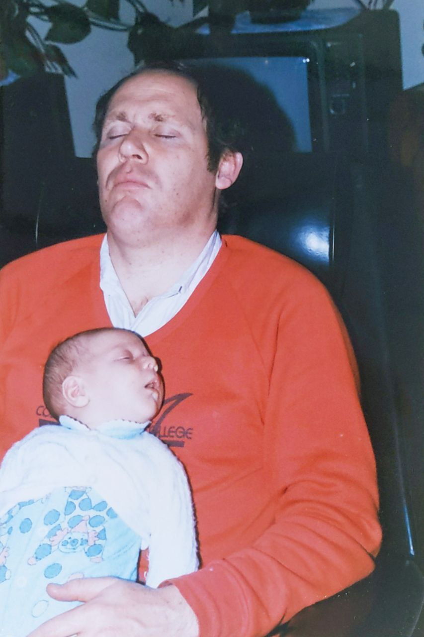 Baby David sleeping on Dad