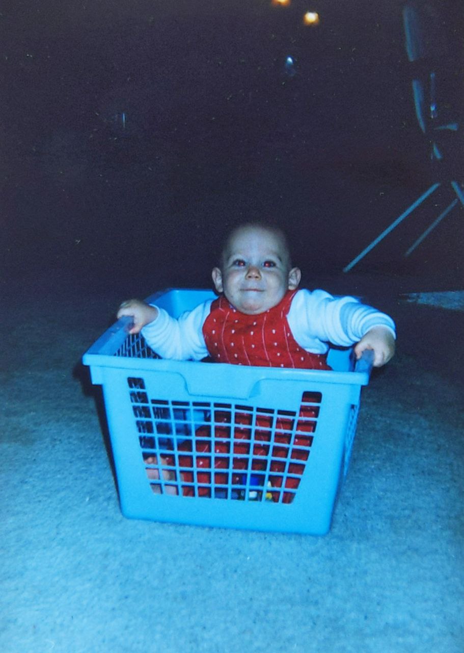 Baby David playing in a basket