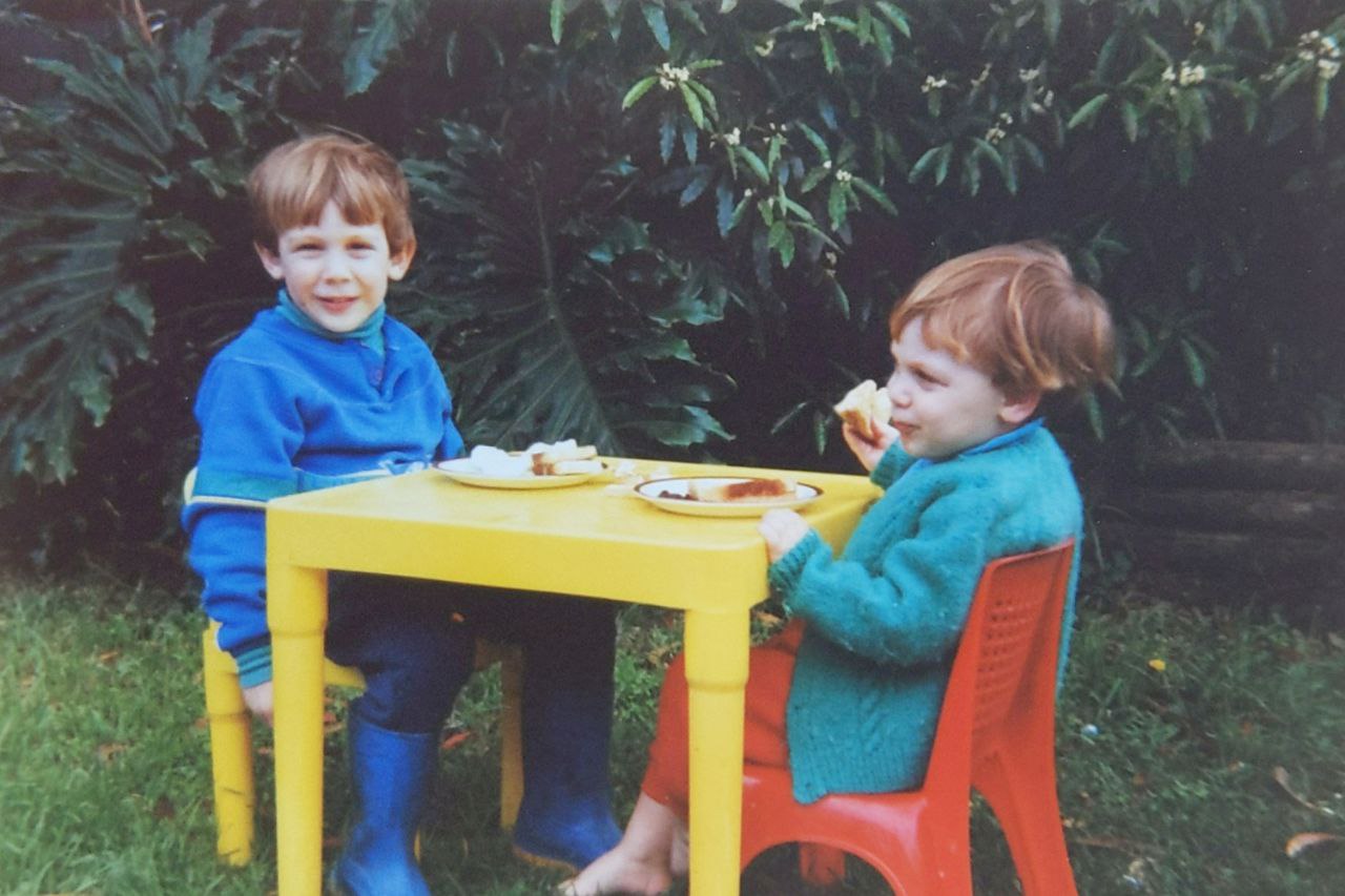 Andrew and David eating at a kiddie table