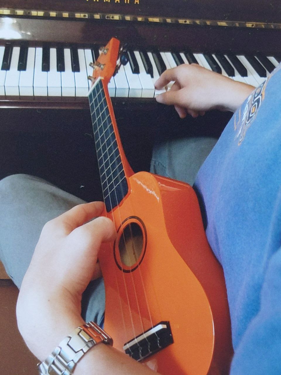 David with at his piano with a ukulele