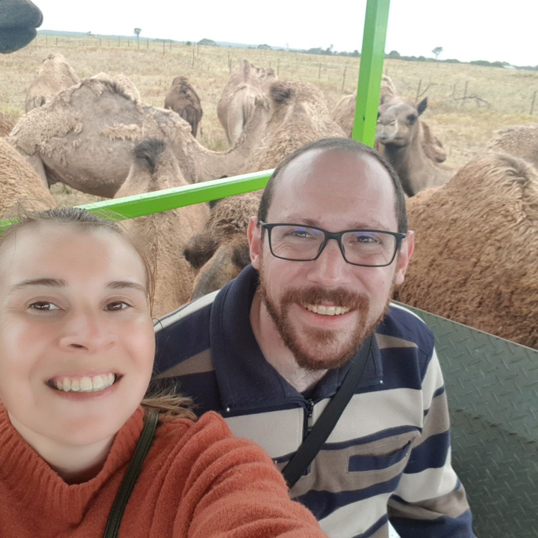 Bree and David surrounded by camels